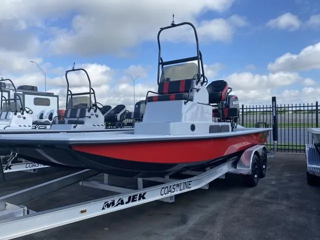 Slide: The Image of 2024 Majek M2 ILLUSION boat on trailer, red and black design, parked outdoors. - 3