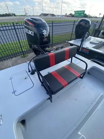 Slide: The Image of 2024 Majek M2 ILLUSION boat with Suzuki outboard motor and red-striped seating. - 5