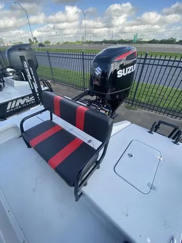 Slide: The Image of 2024 Majek M2 ILLUSION boat with Suzuki outboard motor and red-black seating. - 6