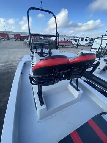 Slide: The Image of 2024 Majek M2 ILLUSION boat with red seating, parked in a marina. - 7