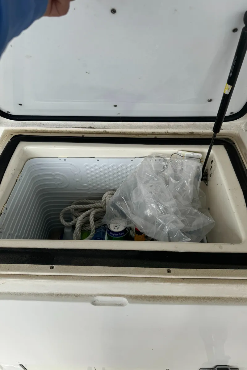 Slide: The Image of Open cooler on 1992 Post 46 Sportfish boat with rope and ice bag inside. - 13