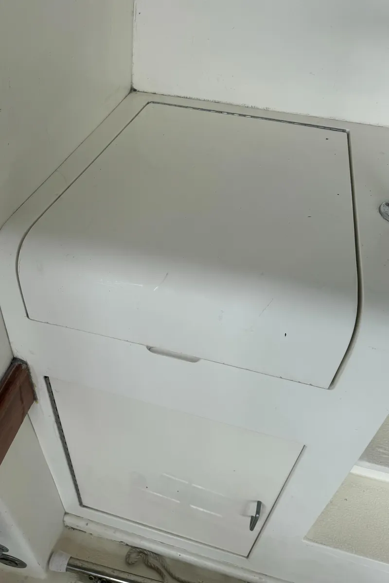 Slide: The Image of 1992 Post 46 Sportfish boat interior storage compartment with white finish. - 14