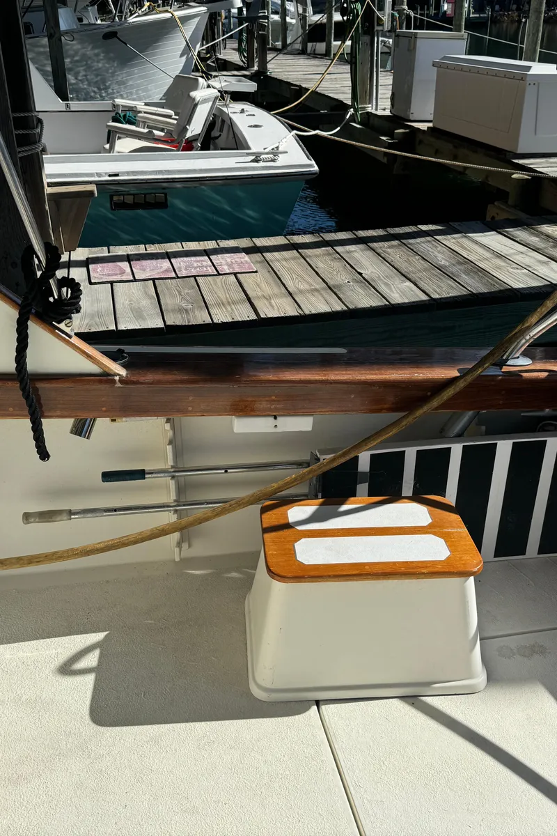 Slide: The Image of 1992 Post 46 Sportfish boat docked, featuring deck details and nearby vessels. - 15