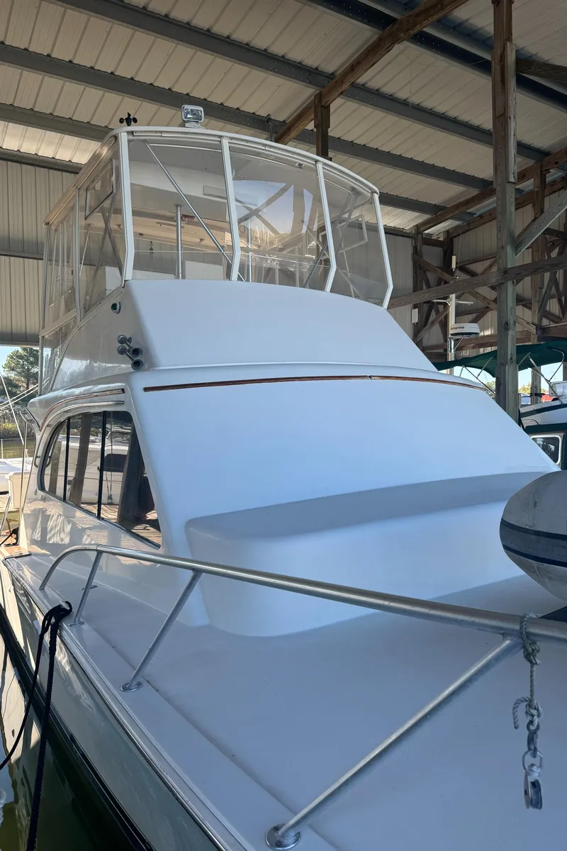 Slide: The Image of 1992 Post 46 Sportfish boat docked in a covered marina. - 17