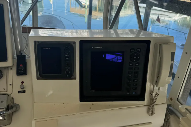 Slide: The Image of 1992 Post 46 Sportfish boat dashboard with navigation equipment and controls. - 24