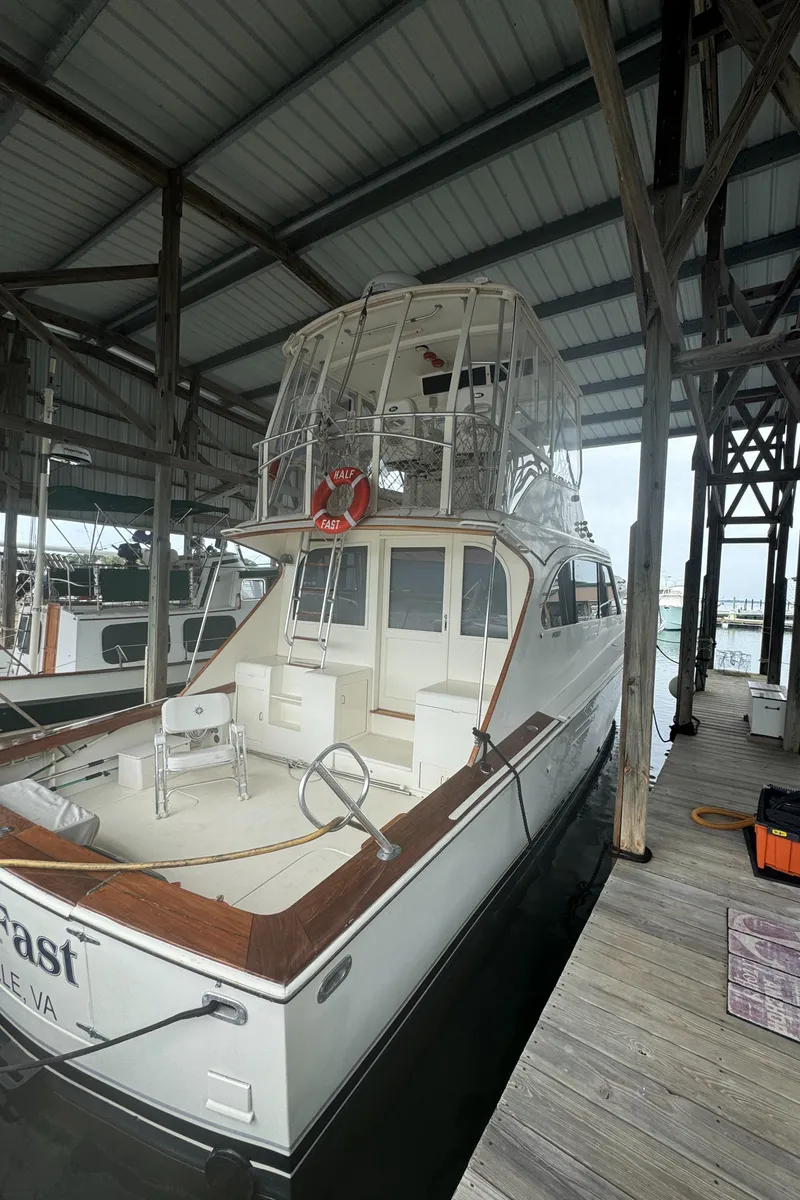 Slide: The Image of 1992 Post 46 Sportfish boat docked under a covered marina. - 3