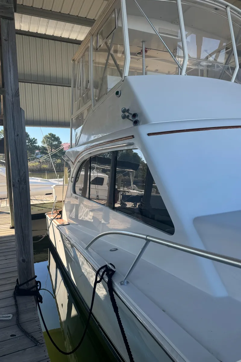 Slide: The Image of 1992 Post 46 Sportfish boat docked under a covered marina. - 33