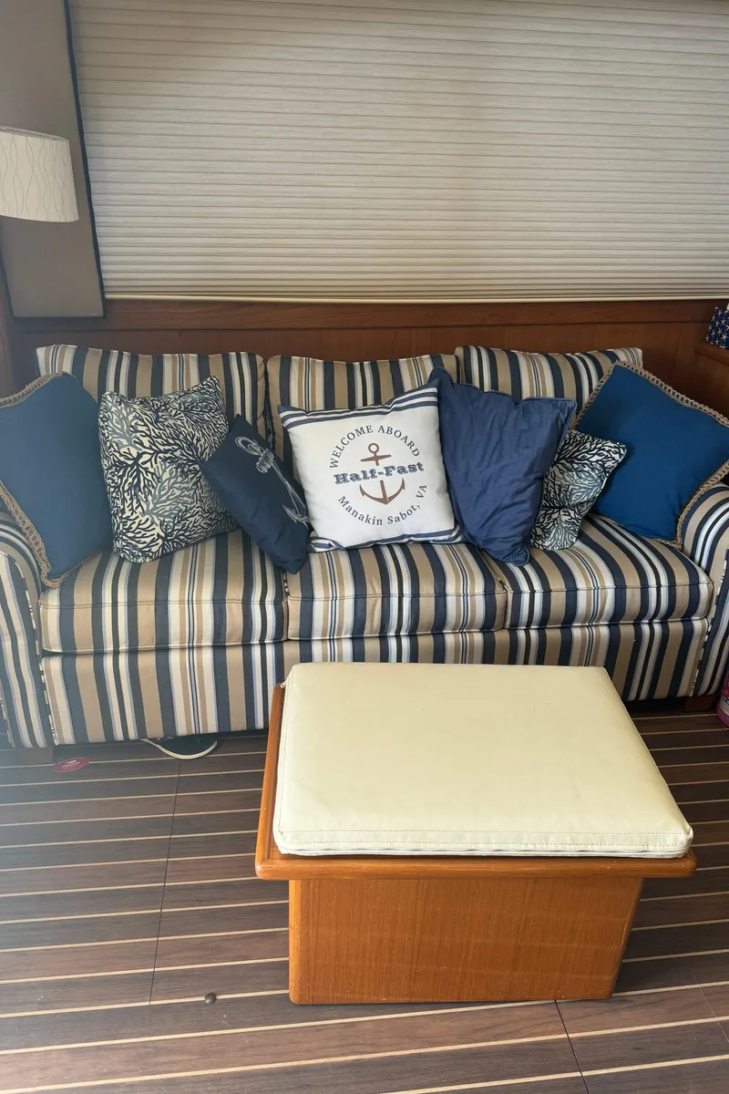 Slide: The Image of Striped sofa with nautical-themed pillows on a 1992 Post 46 Sportfish boat interior. - 38