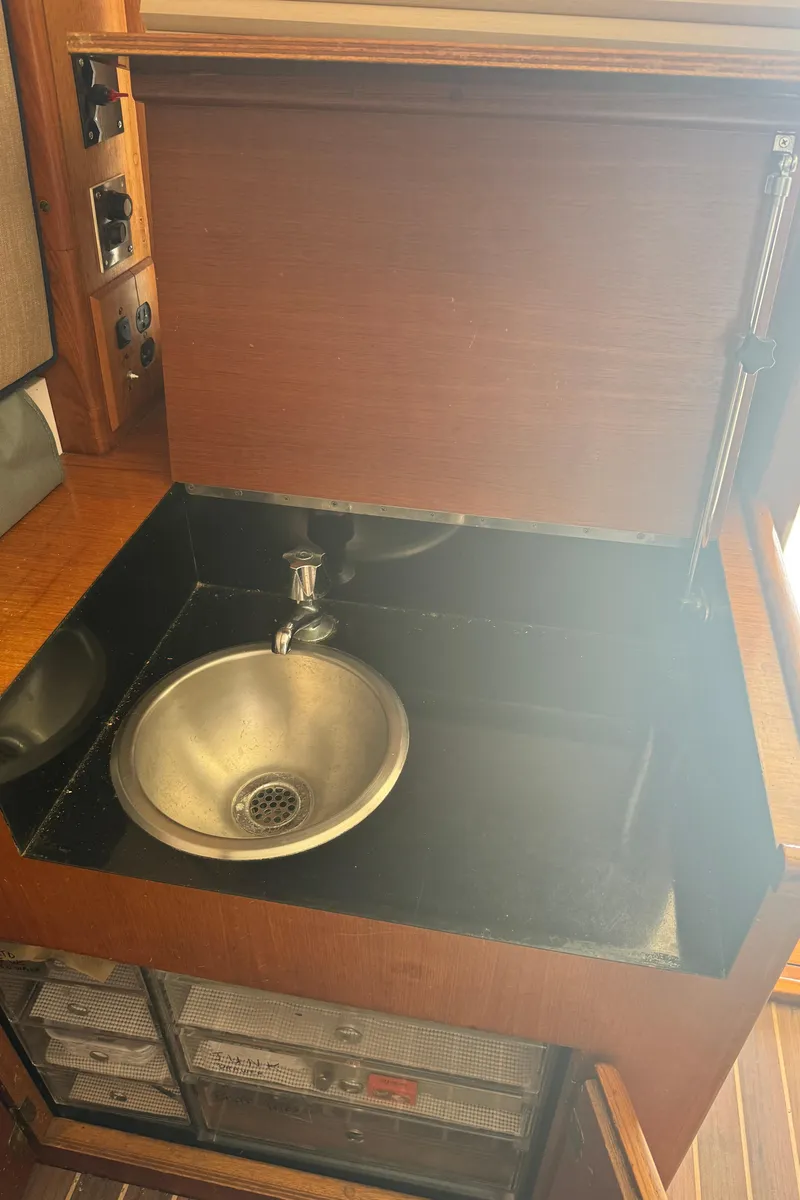 Slide: The Image of 1992 Post 46 Sportfish yacht interior with stainless steel sink and wooden cabinetry. - 42