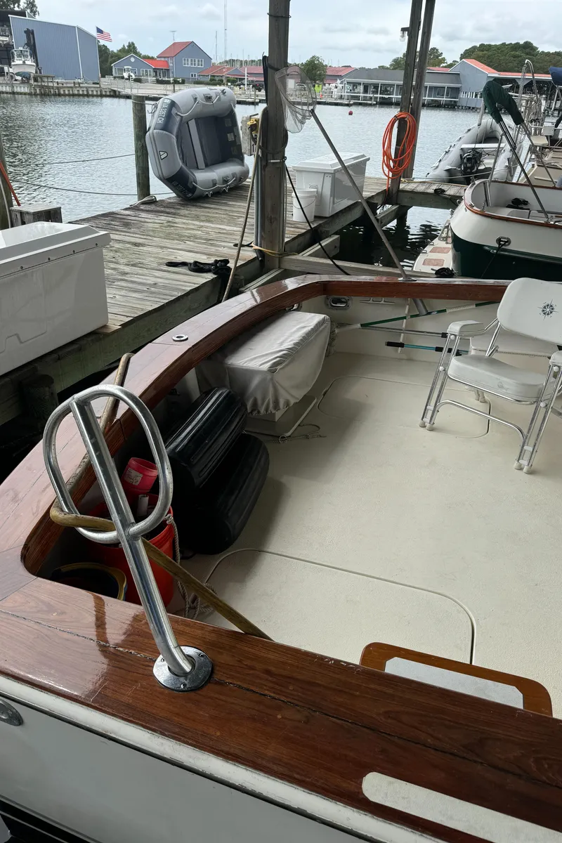 Slide: The Image of 1992 Post 46 Sportfish boat docked, featuring spacious deck and seating area. - 9