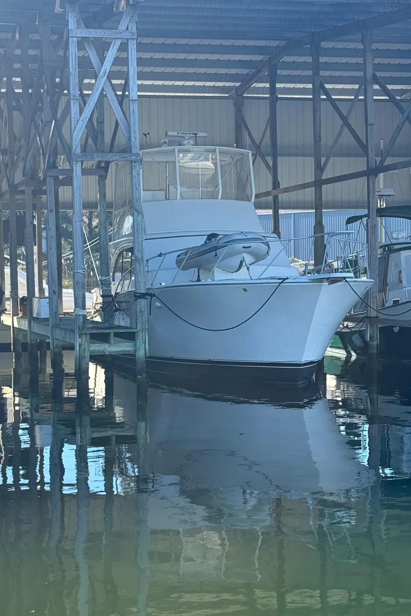 The Image of 1992 Post 46 Sportfish boat docked in a covered marina. - 0