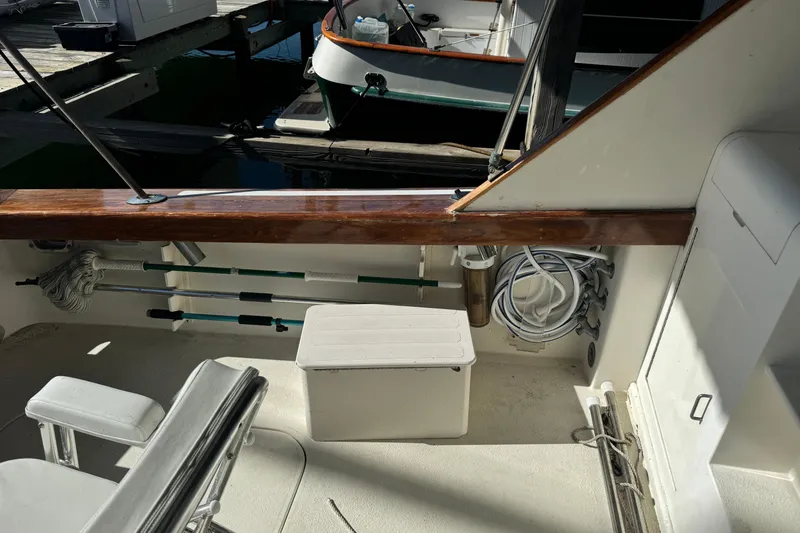 Slide: The Image of 1992 Post 46 Sportfish boat deck with seating, storage, and fishing rods. - 10