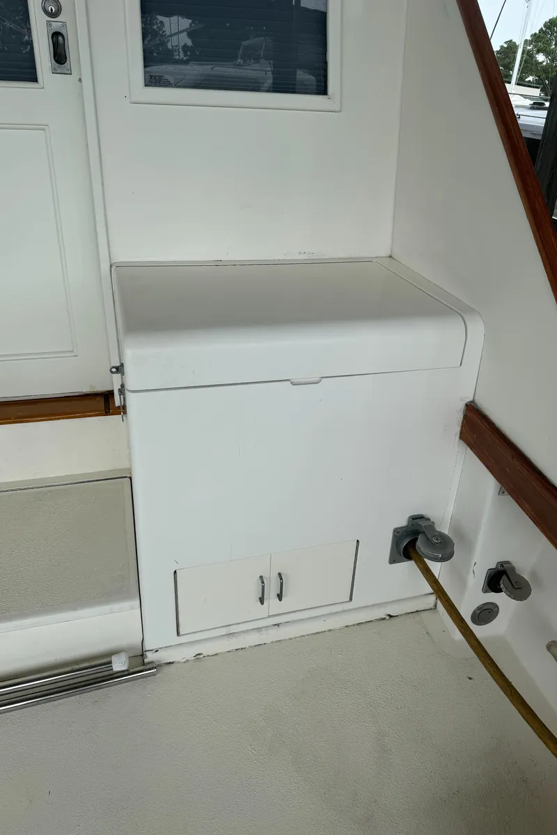 Slide: The Image of 1992 Post 46 Sportfish boat interior with white storage compartment. - 12