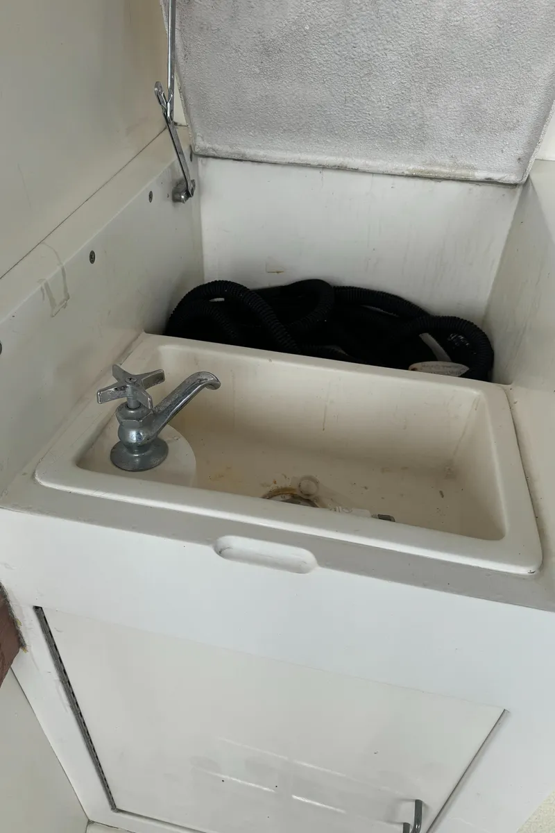 Slide: The Image of 1992 Post 46 Sportfish boat sink with faucet and storage compartment. - 16
