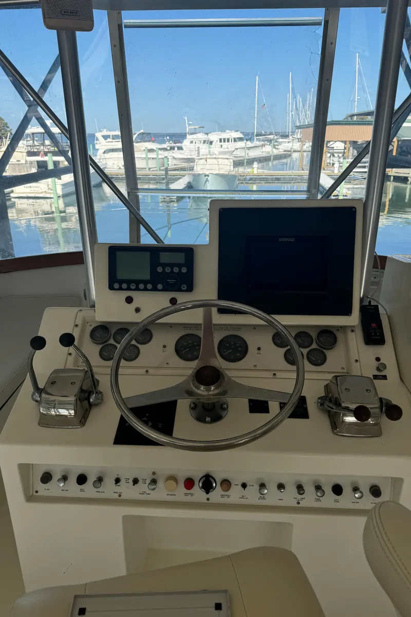 Slide: The Image of Helm of 1992 Post 46 Sportfish boat with steering wheel and control panel. - 21