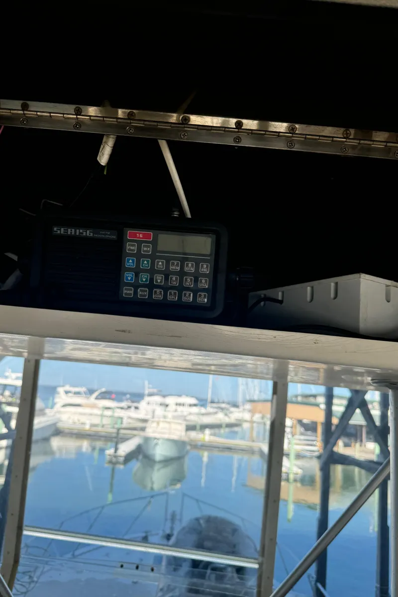 Slide: The Image of 1992 Post 46 Sportfish boat interior with electronic equipment and marina view. - 26
