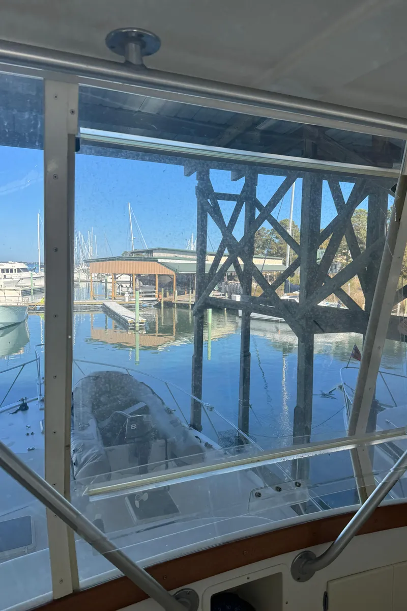 Slide: The Image of View from 1992 Post 46 Sportfish boat, overlooking marina with clear blue sky. - 29