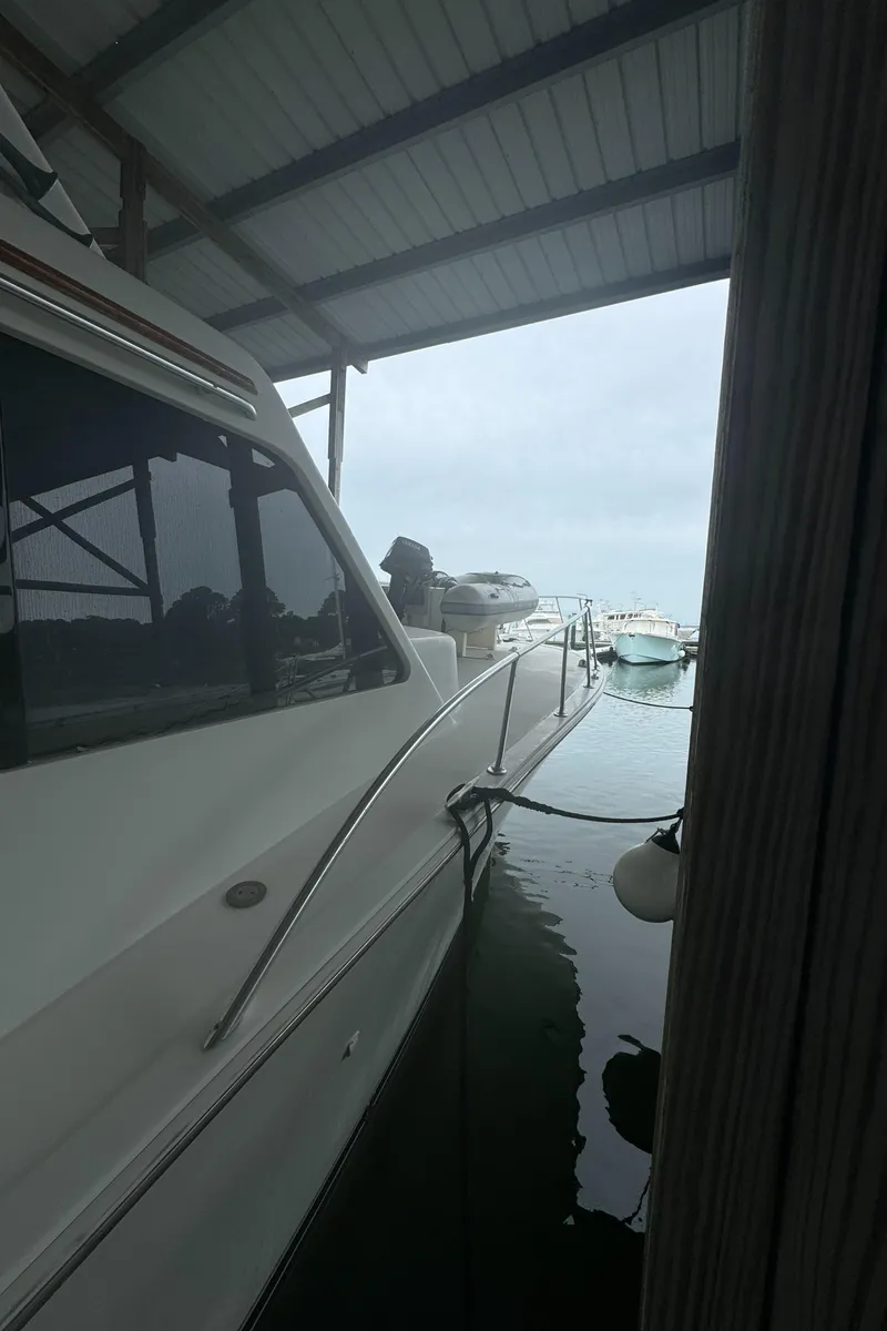 Slide: The Image of 1992 Post 46 Sportfish yacht docked under a covered marina. - 4