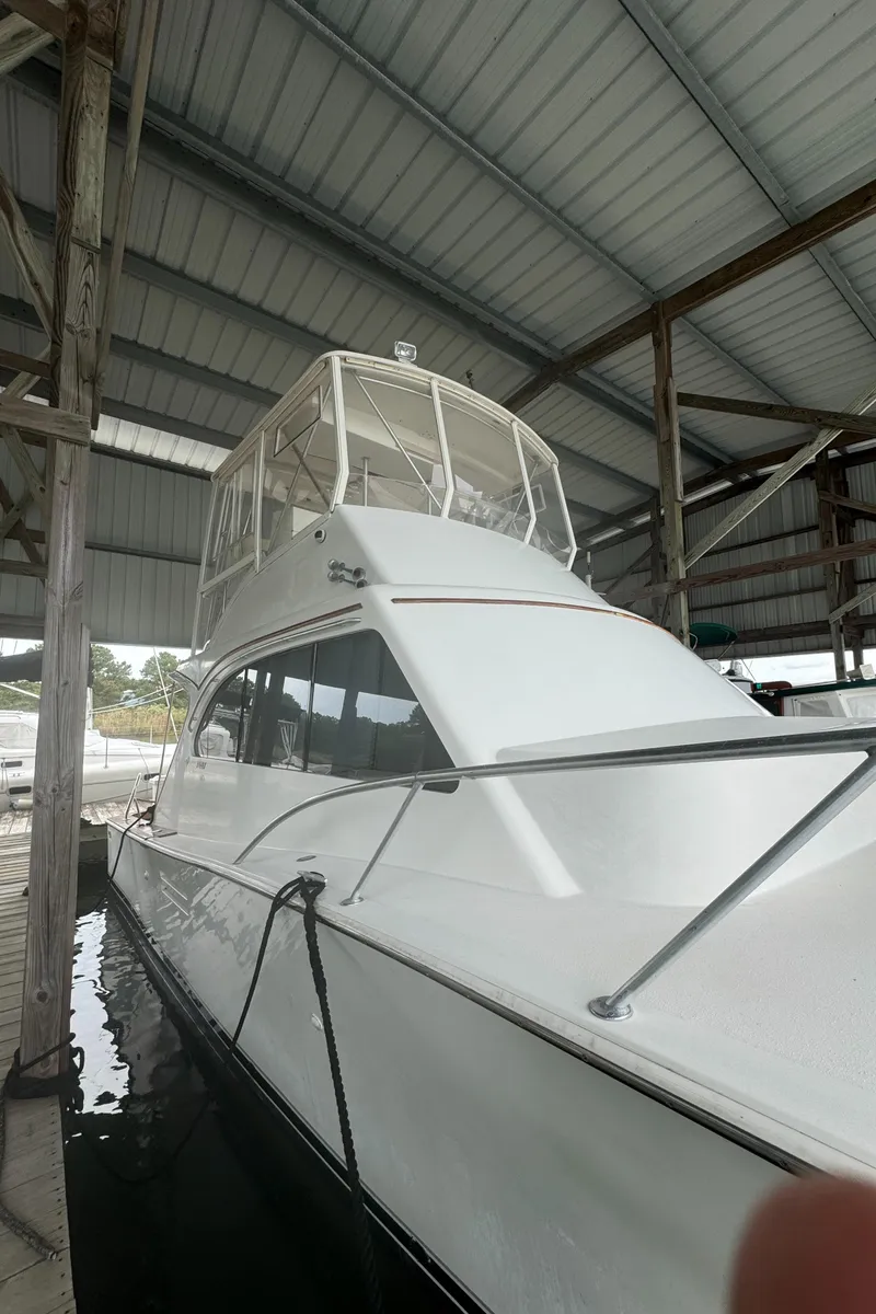 Slide: The Image of 1992 Post 46 Sportfish yacht docked under a covered marina. - 5