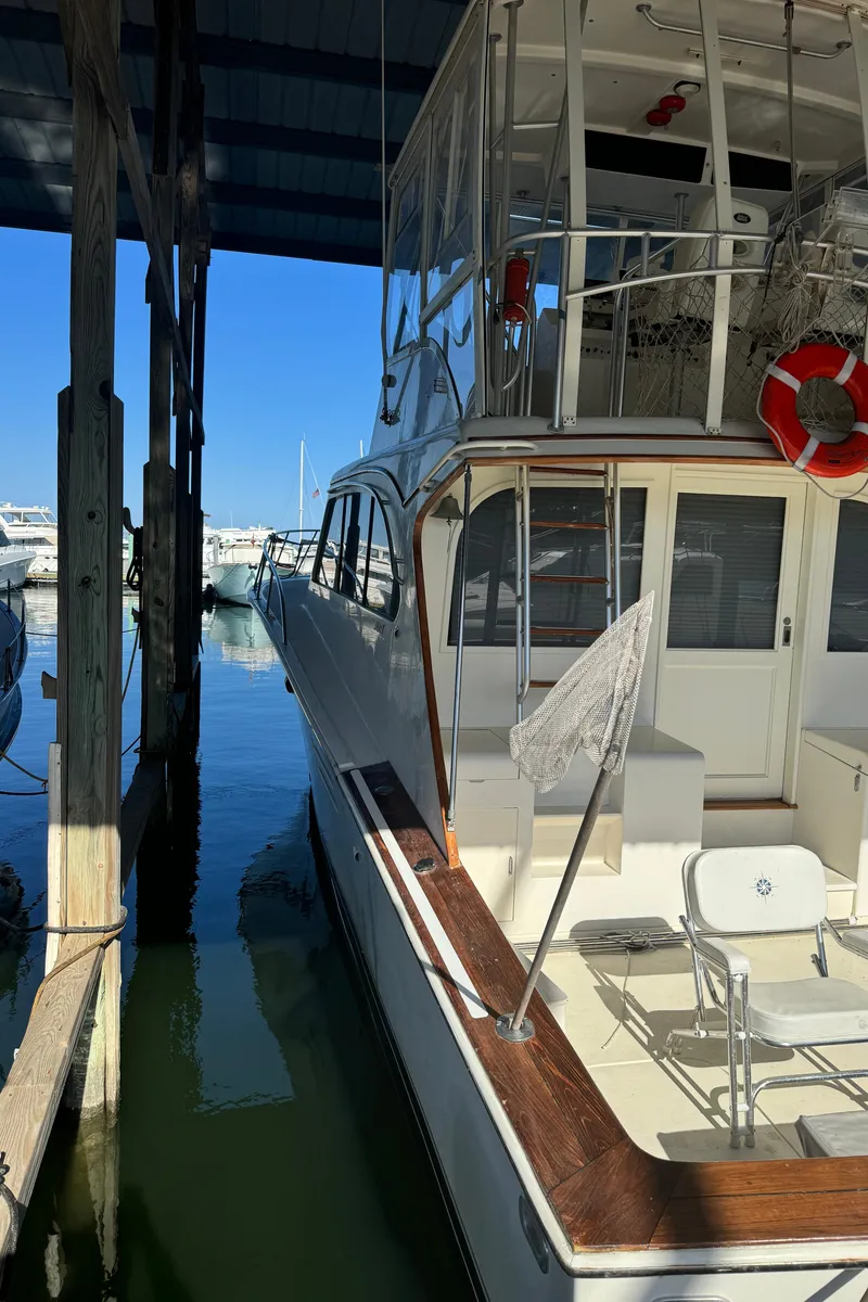 Slide: The Image of 1992 Post 46 Sportfish yacht docked in marina, featuring upper deck and fishing equipment. - 8