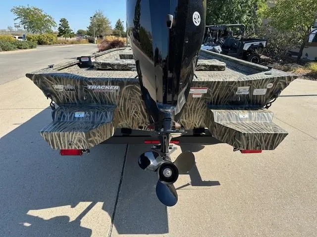 Slide: The Image of 2025 Tracker Grizzly 1860 CC boat with camouflage design and outboard motor. - 3