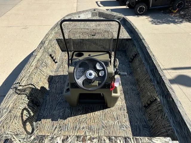 Slide: The Image of 2025 Tracker Grizzly 1860 CC boat with camouflage design and central steering console. - 5