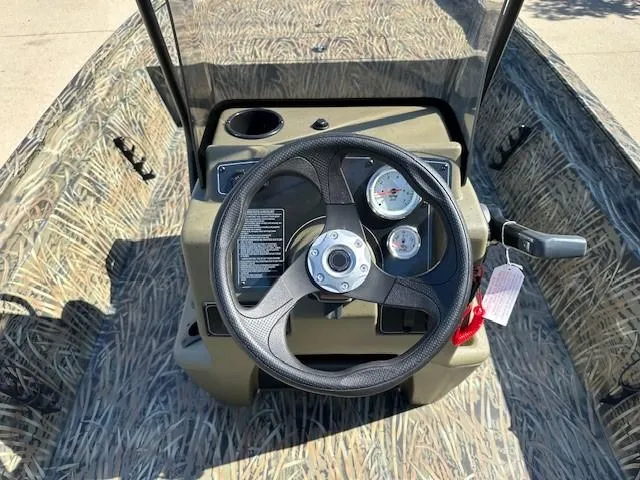 Slide: The Image of 2025 Tracker Grizzly 1860 CC boat dashboard with steering wheel and gauges. - 6