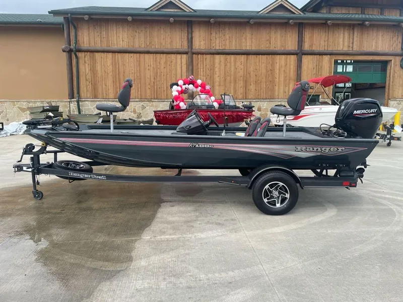 Slide: The Image of 2024 Ranger RT188C fishing boat with Mercury engine, parked outdoors. - 0