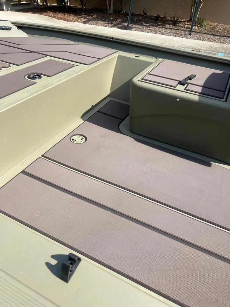 Slide: The Image of 2025 Tracker Grizzly 1754 SC boat interior with spacious deck and storage compartments. - 11