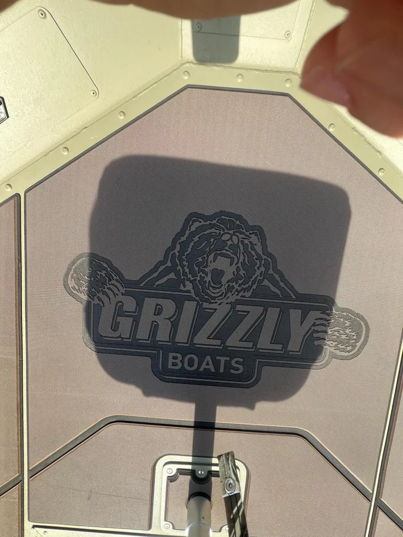 Slide: The Image of 2025 Tracker Grizzly 1754 SC boat interior with logo shadow. - 14
