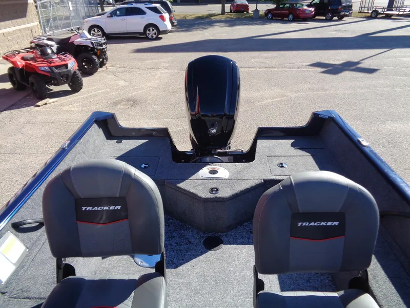 Slide: The Image of 2025 Tracker Pro Guide V-16 WT boat interior with motor and seating. - 11