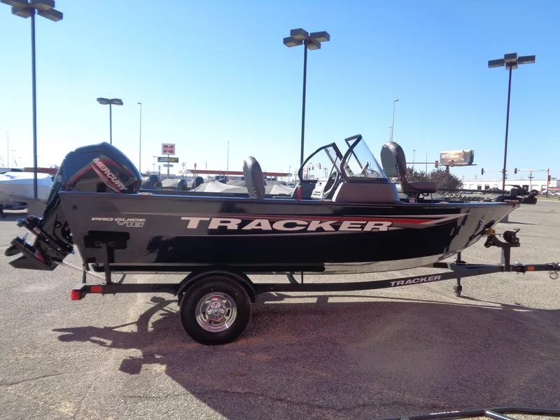 Slide: The Image of 2025 Tracker Pro Guide V-16 WT boat on trailer in parking lot. - 3
