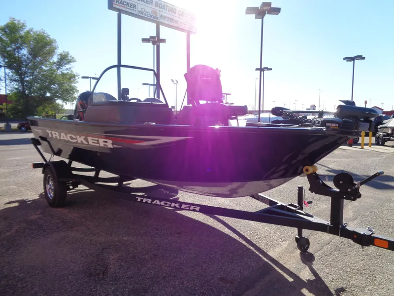 Slide: The Image of 2025 Tracker Pro Guide V-16 WT boat on trailer in outdoor dealership lot. - 4