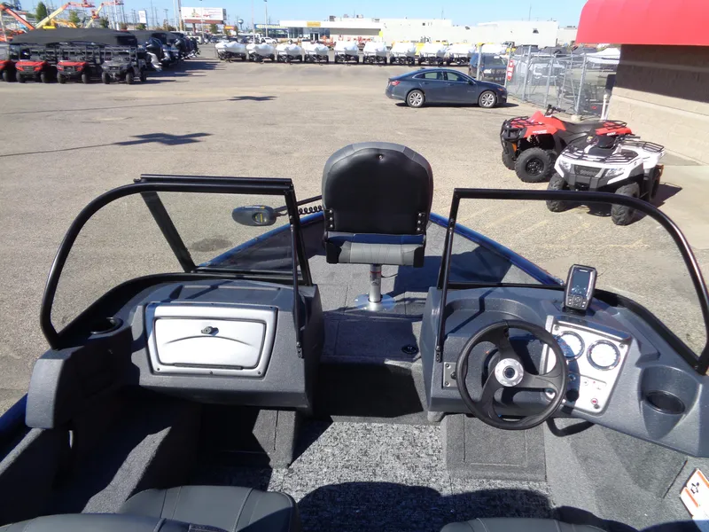 Slide: The Image of 2025 Tracker Pro Guide V-16 WT boat interior with steering console and seating. - 6