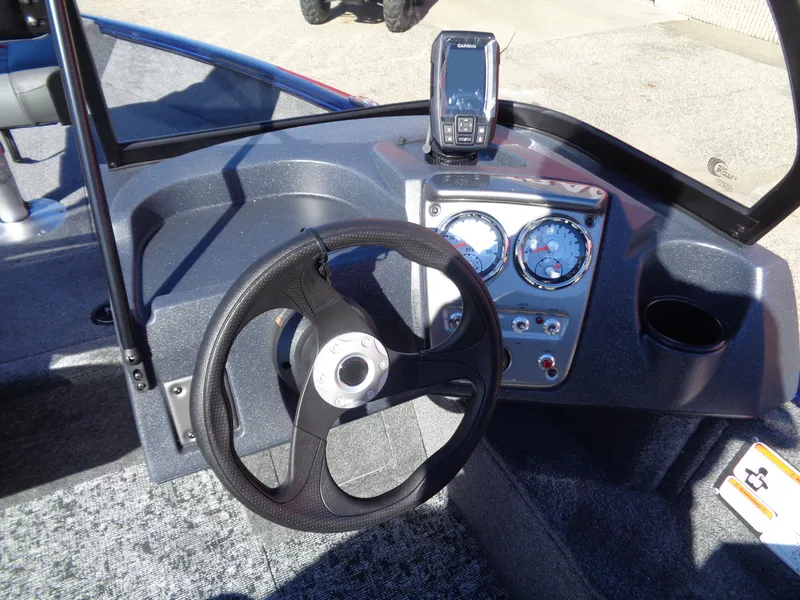 Slide: The Image of 2025 Tracker Pro Guide V-16 WT boat dashboard with steering wheel and gauges. - 7