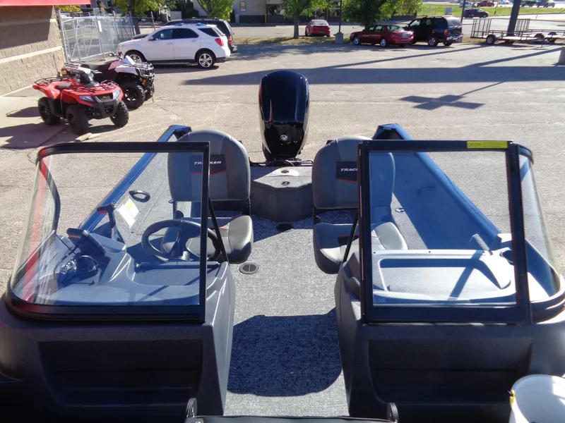Slide: The Image of 2025 Tracker Pro Guide V-16 WT boat interior with seating and steering wheel. - 9
