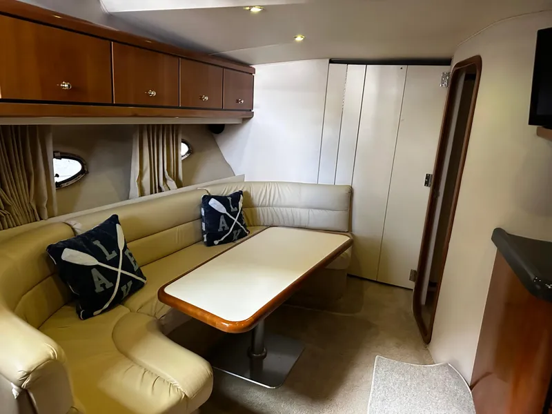Slide: The Image of Interior of 2000 Carver 400 Express Yacht with beige seating and dining table. - 13