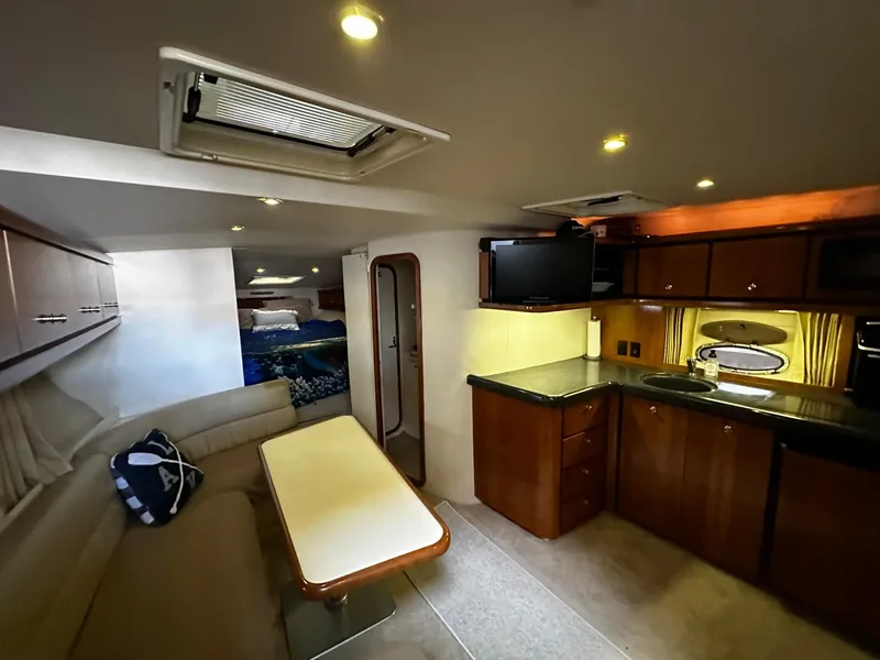 Slide: The Image of Interior of 2000 Carver 400 Express Yacht with kitchen and seating area. - 14