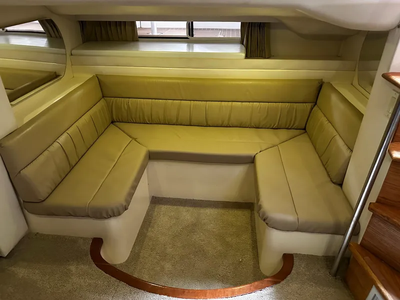 Slide: The Image of Interior seating area of 2000 Carver 400 Express Yacht with beige upholstery. - 18