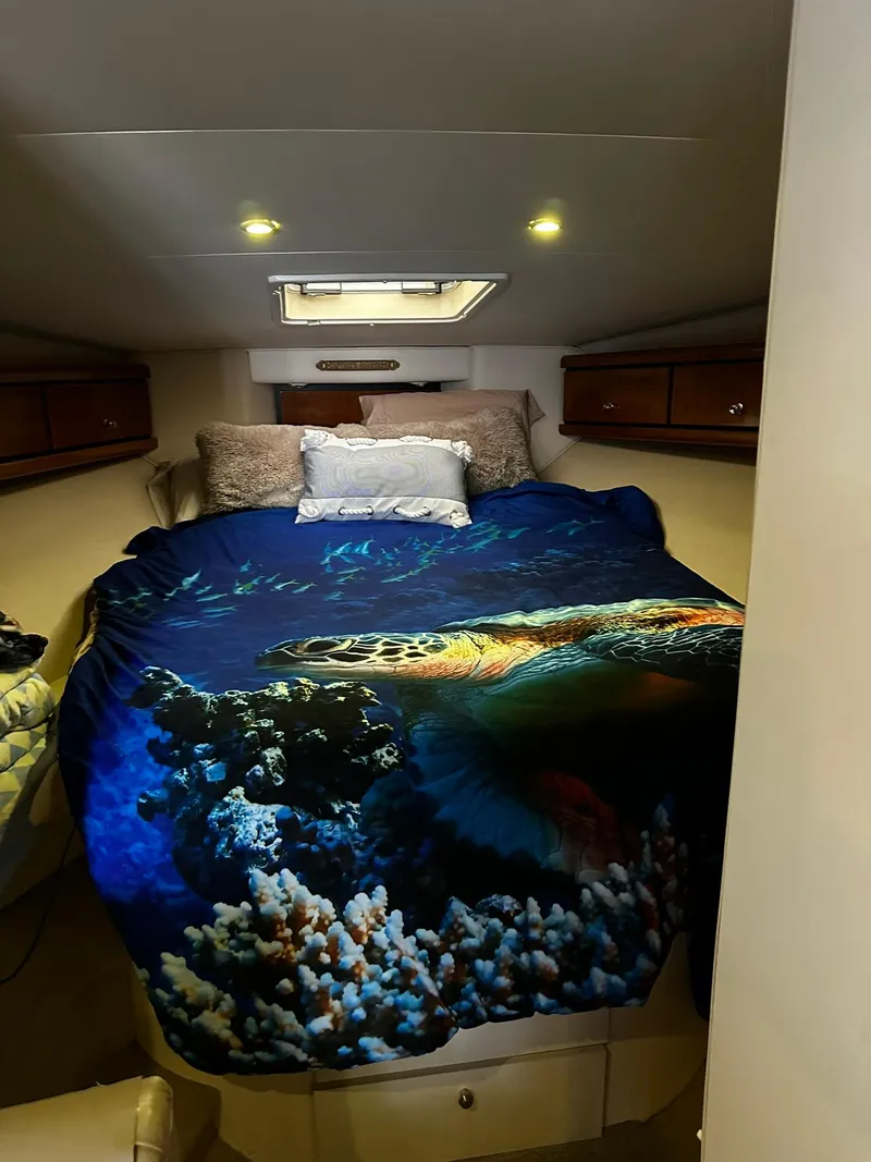 Slide: The Image of Cozy bedroom in 2000 Carver 400 Express Yacht with ocean-themed bedding. - 19