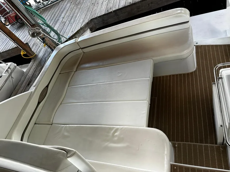 Slide: The Image of Carver 400 Express Yacht 2000, white leather seating, docked on wooden pier. - 23