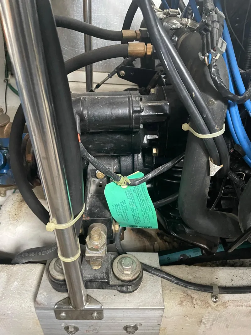 Slide: The Image of Engine compartment of a 2000 Carver 400 Express Yacht with visible wiring and components. - 26