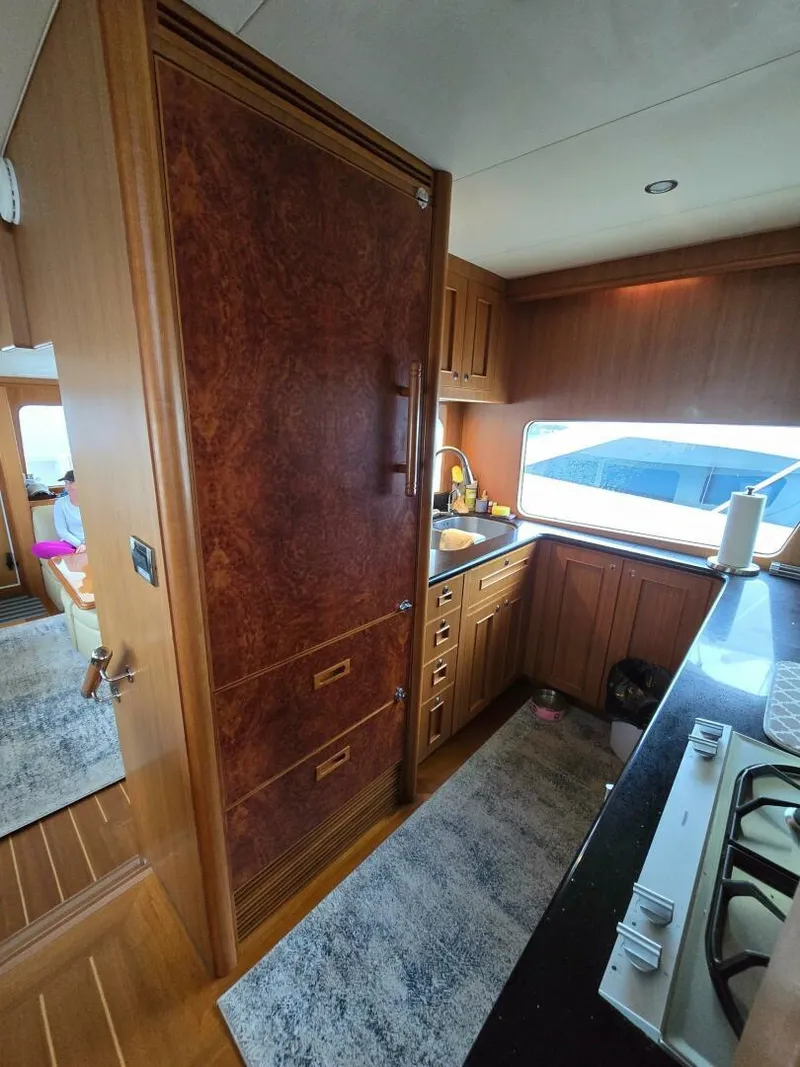 Slide: The Image of Luxurious kitchen interior of 2010 Ocean Alexander Classico yacht with wood cabinetry. - 11
