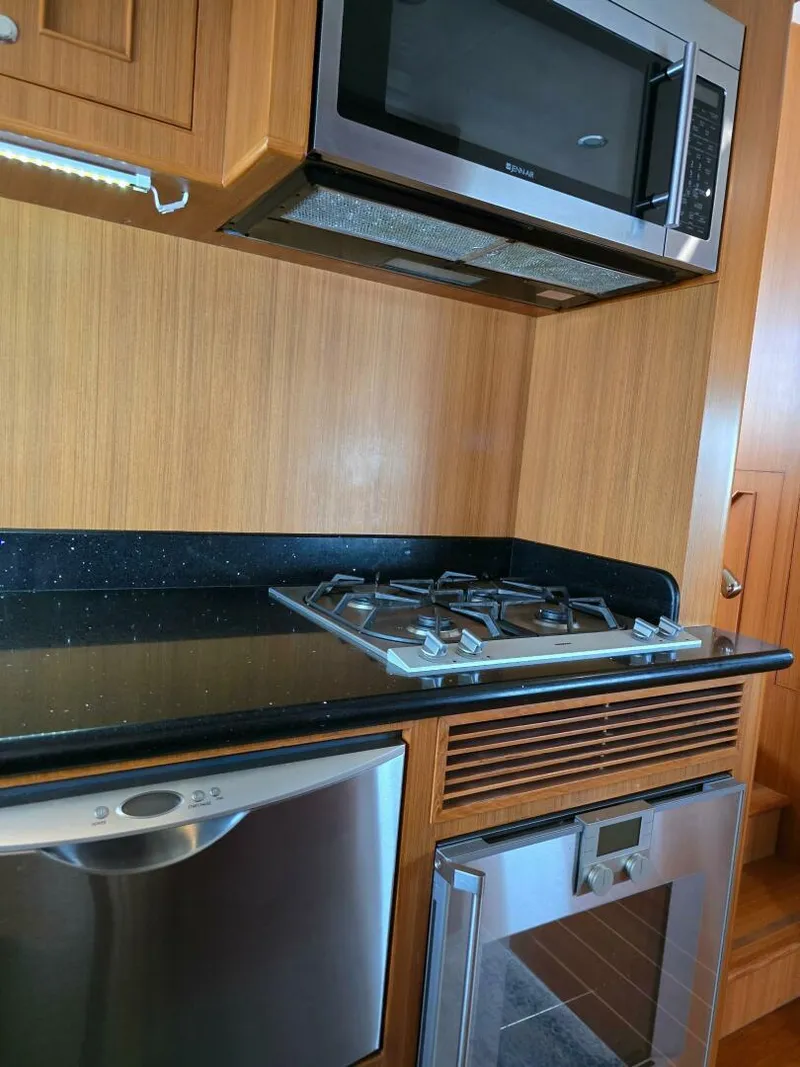 Slide: The Image of Modern kitchen in 2010 Ocean Alexander Classico yacht with stove, microwave, and dishwasher. - 15