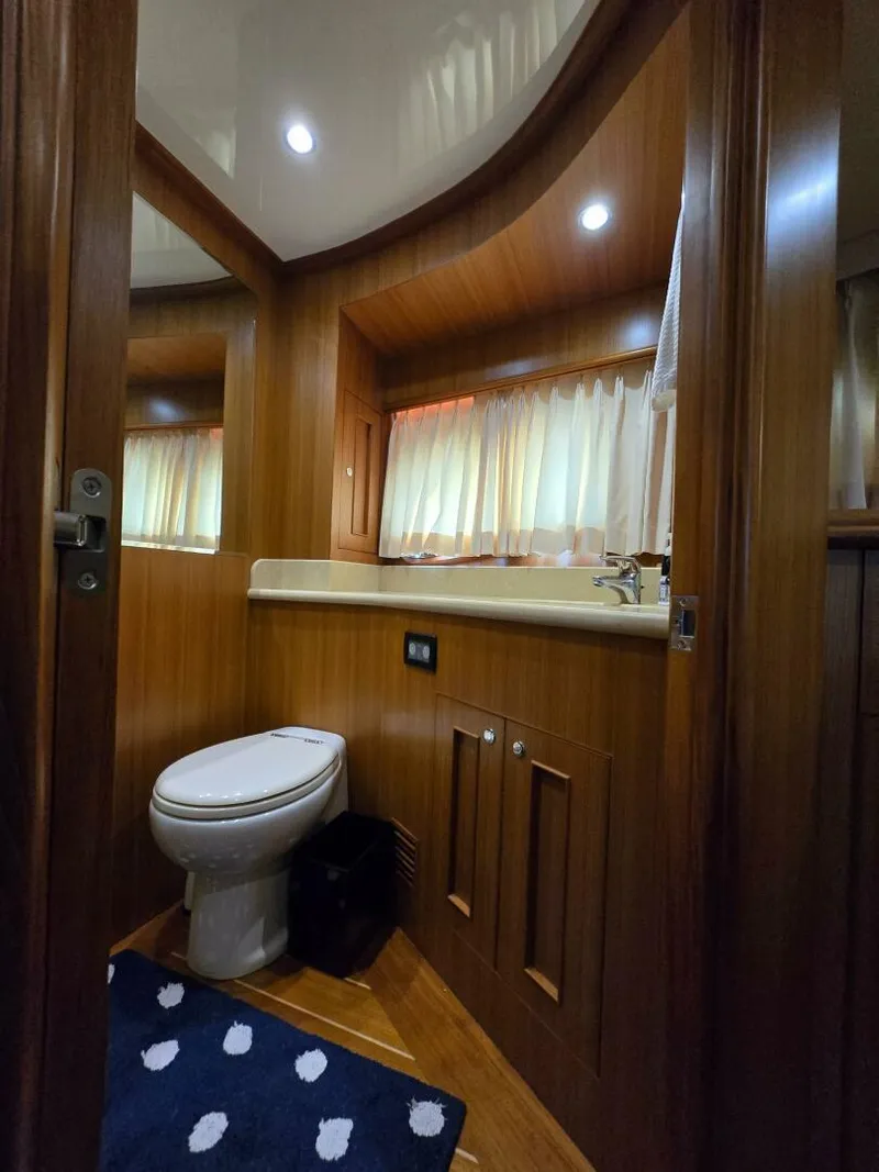 Slide: The Image of Luxurious 2010 Ocean Alexander Classico yacht bathroom with wood paneling and modern fixtures. - 26