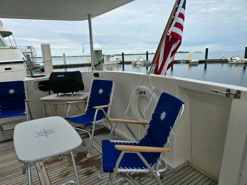 Slide: The Image of 2010 Ocean Alexander Classico yacht deck with chairs, table, and American flag. - 42