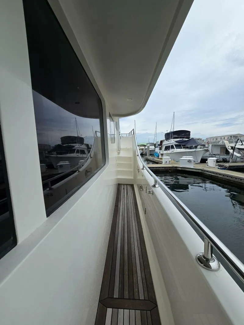 Slide: The Image of 2010 Ocean Alexander Classico yacht docked at marina, side deck view. - 44