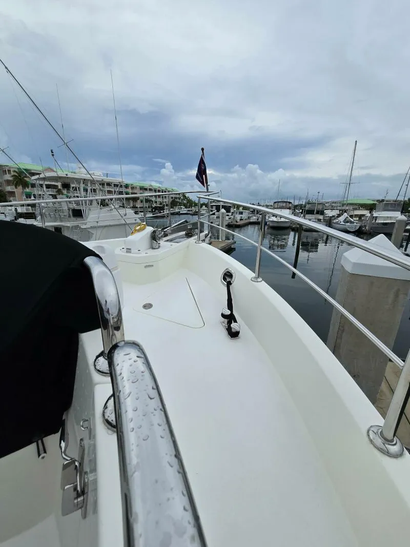 Slide: The Image of 2010 Ocean Alexander Classico yacht docked at marina under cloudy sky. - 45