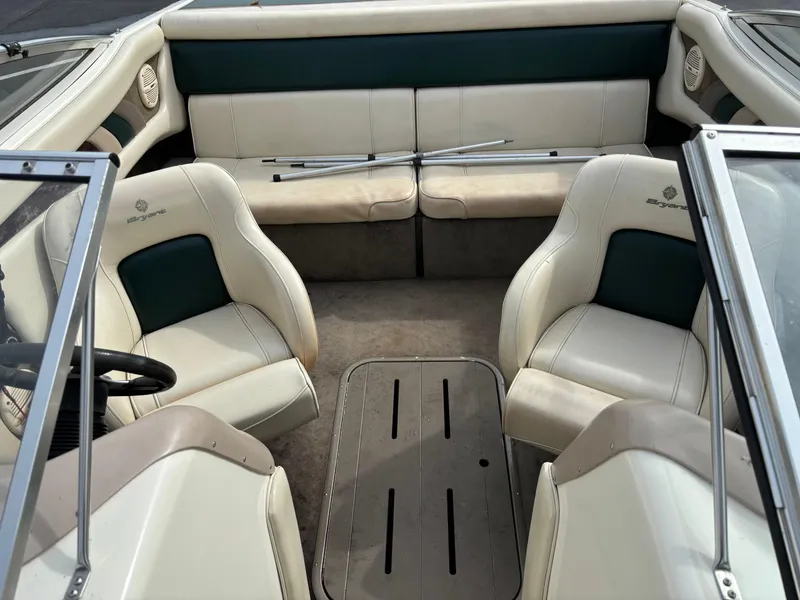 Slide: The Image of 2002 Bryant 214 boat interior with white and green seating, open cockpit design. - 5