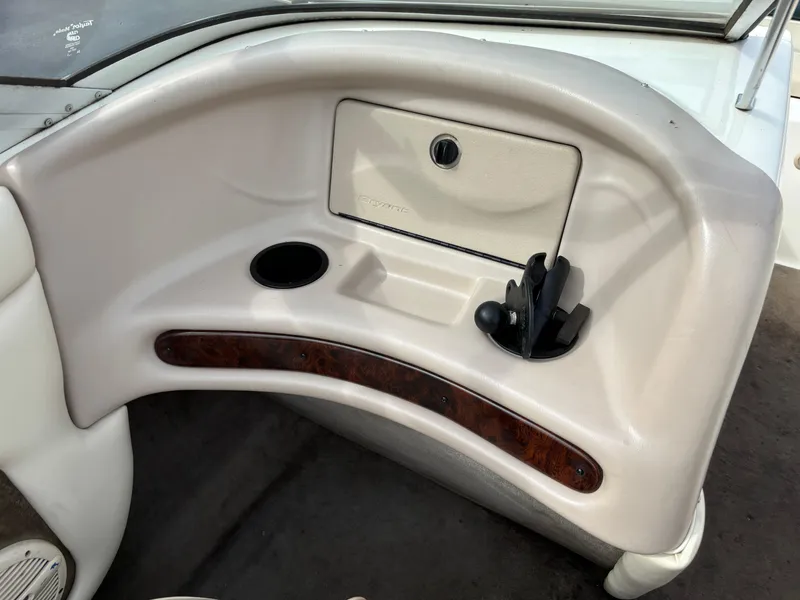 Slide: The Image of 2002 Bryant 214 boat dashboard with cup holder and storage compartment. - 7